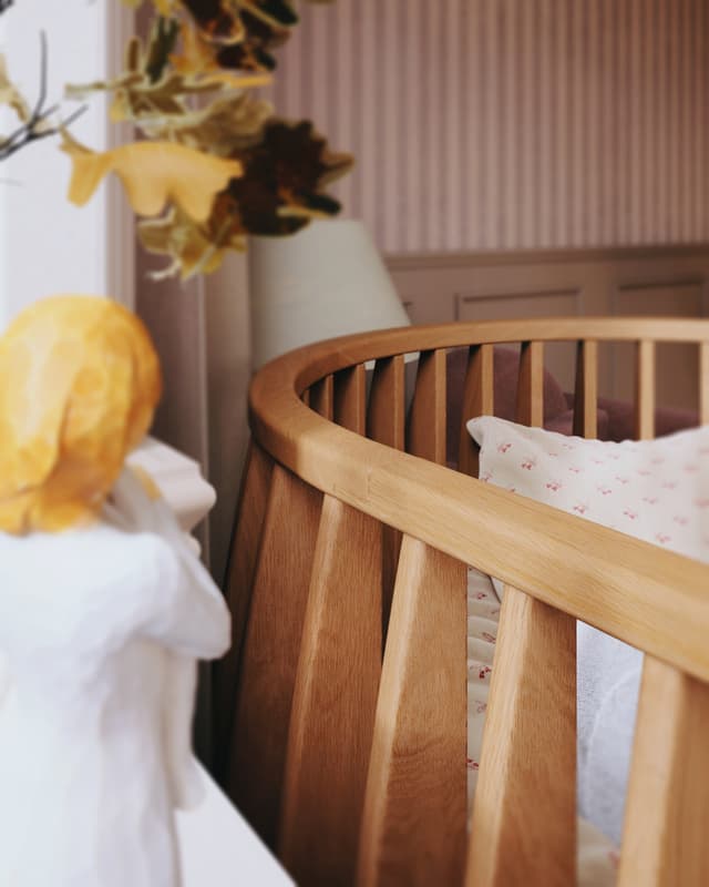 Sol Baby wooden crib with soft bedding in an elegant nursery